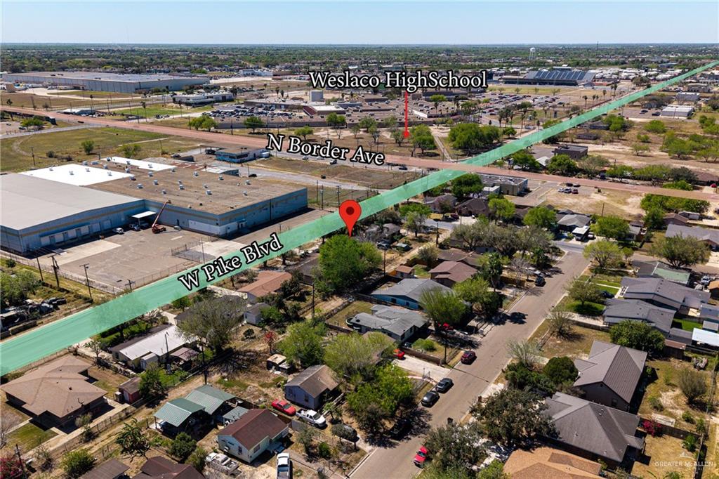 610 West Pike Boulevard Weslaco, TX 78596 - Photo 3 of 15 Aerial view of property and surrounding area with nearby suburban area and an industrial area