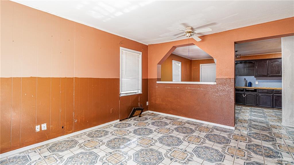 610 West Pike Boulevard Weslaco, TX 78596 - Photo 8 of 15 Unfurnished room with wooden walls and ceiling fan