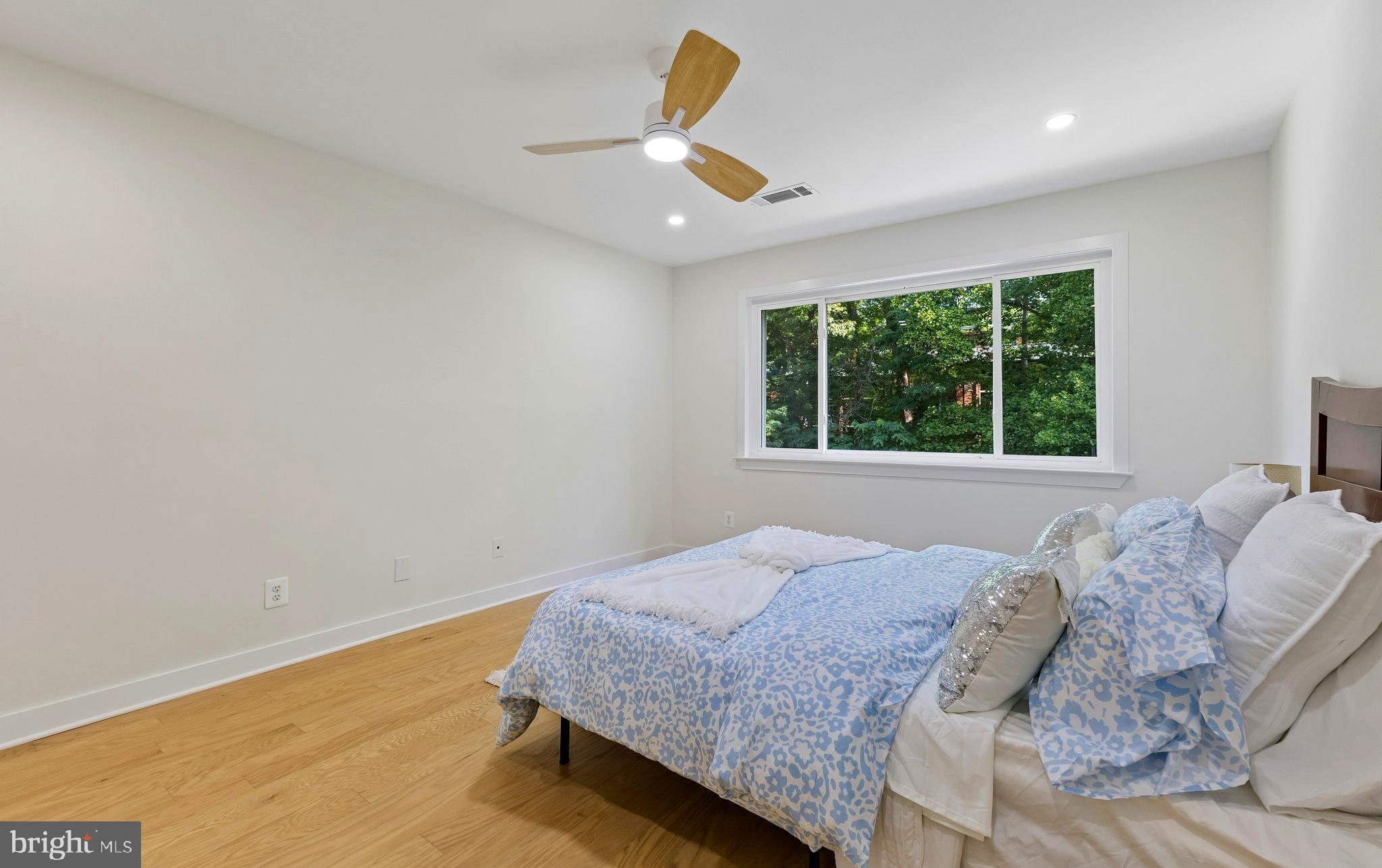 11841 Shire Court, Unit 31D Reston, VA 20191 - Photo 20 of 24 a bedroom with a bed a window and a couch