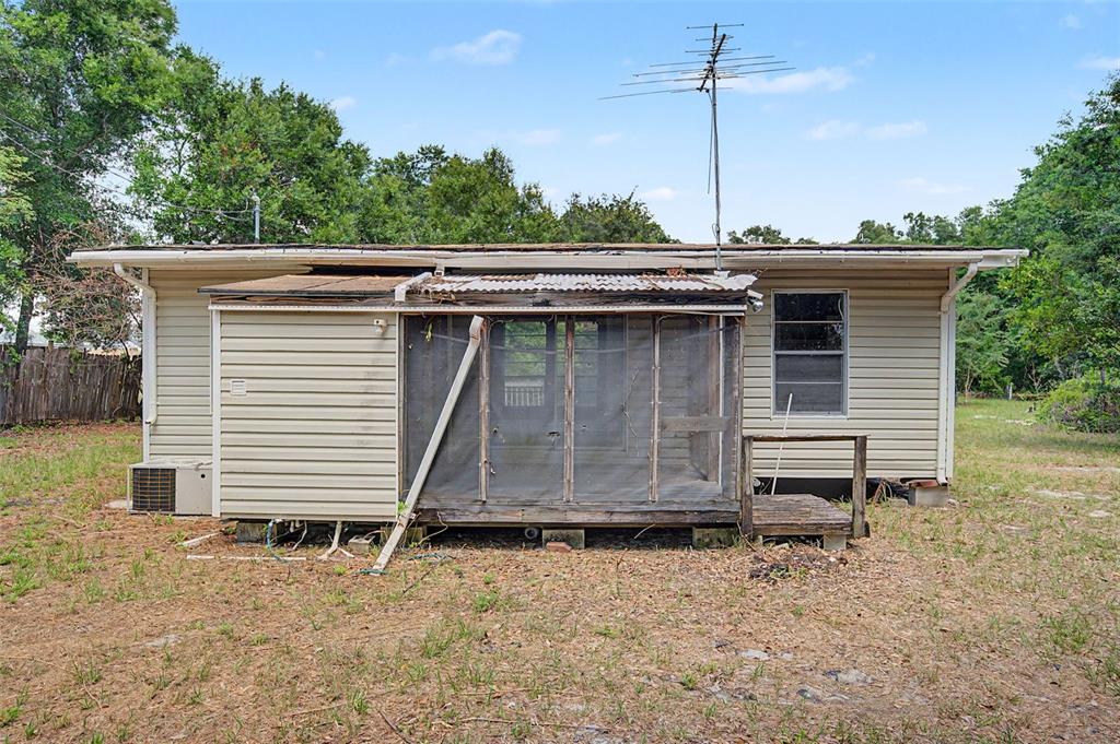 Cutrone Road Winter Haven, FL 33880 - Photo 11 of 50 a view of a house with a yard and wooden fence