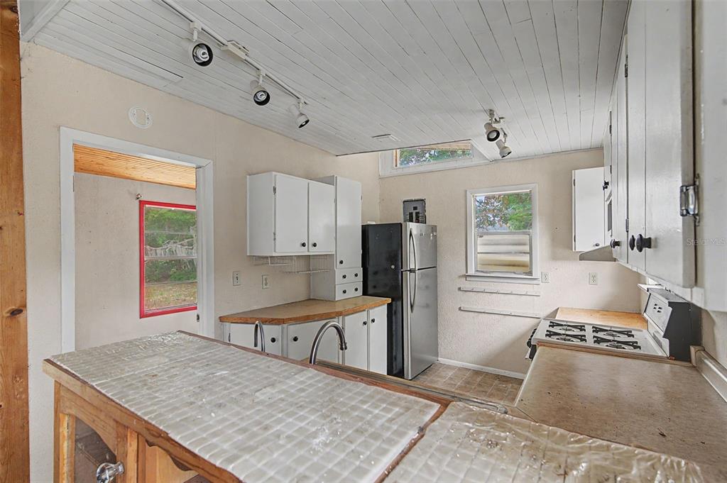 Cutrone Road Winter Haven, FL 33880 - Photo 23 of 50 a kitchen with stainless steel appliances granite countertop a sink stove and refrigerator