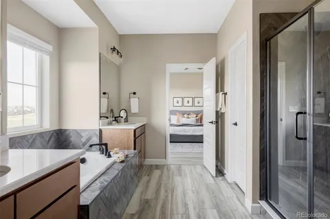 a spacious bathroom with a granite countertop tub sink and mirror