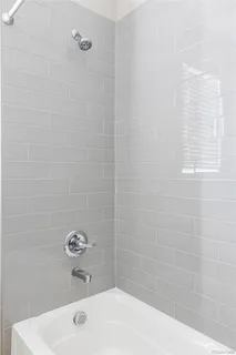 a bathroom with a sink a window and shower