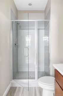 a bathroom with a glass shower door