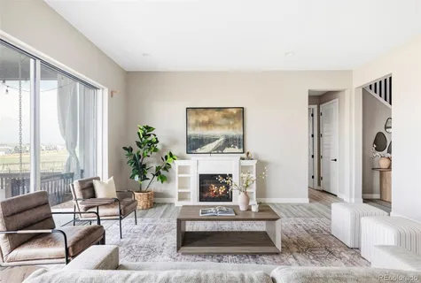 a living room with furniture a window and a fireplace