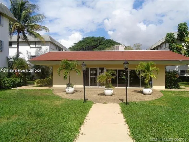 a view of a house with a backyard porch and sitting area