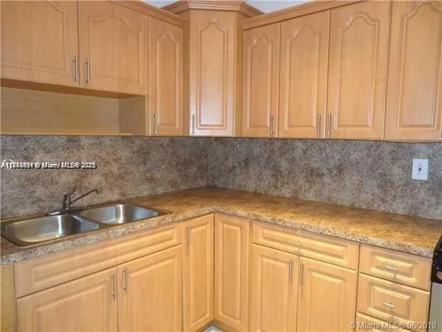 a kitchen with a sink and cabinets