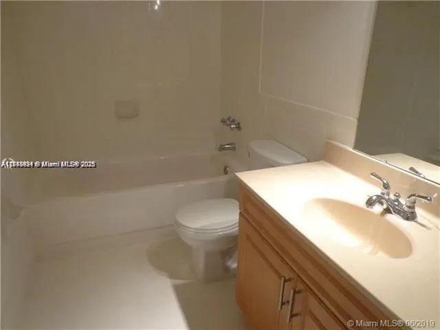 a bathroom with a sink a toilet and bathtub