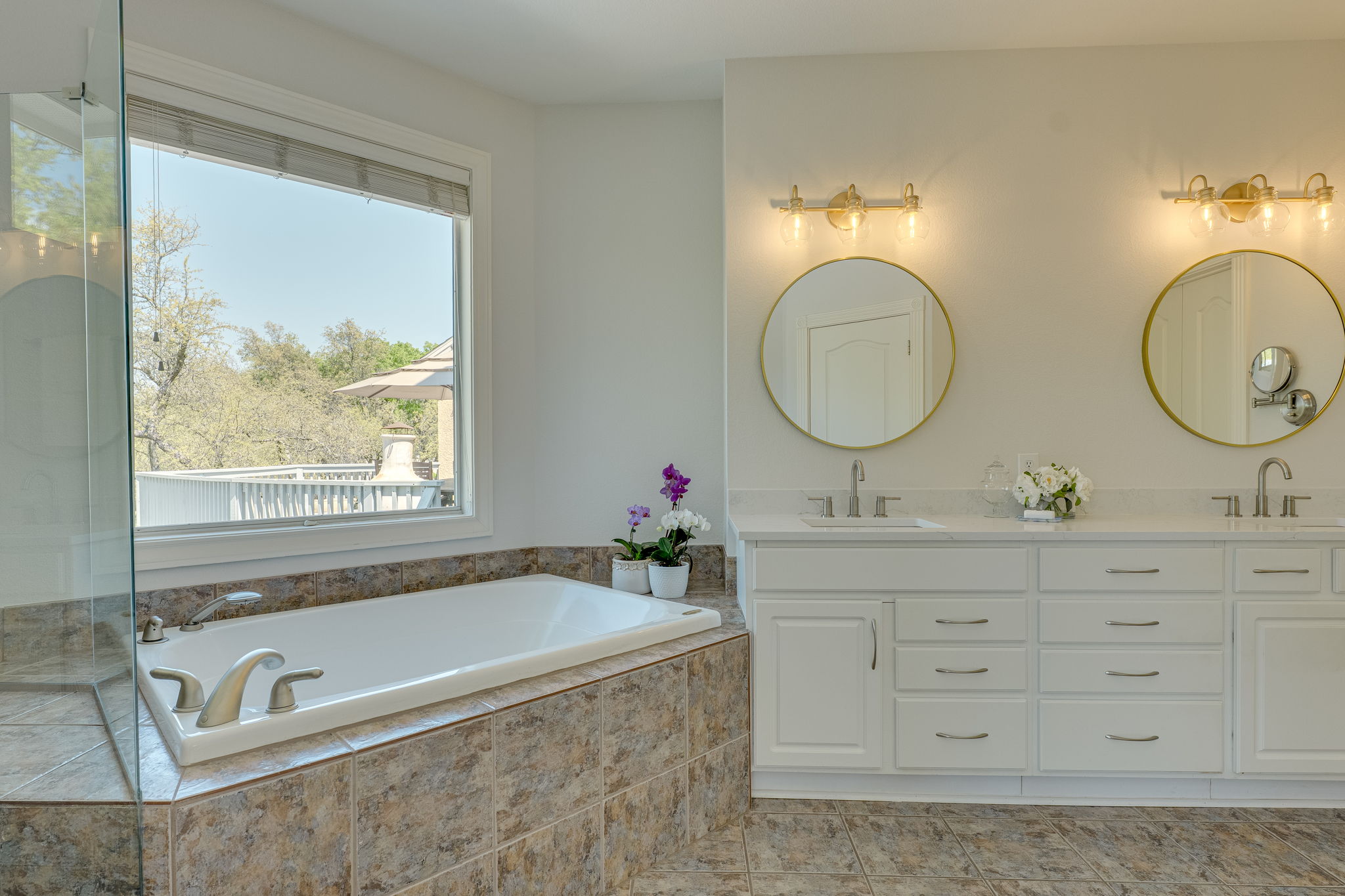 4424 Lago Viento Austin, TX 78734 - Photo 21 of 38 Primary bath has a window for natural light, walk-in frameless shower, dual sinks, water closet and walk-in closet.