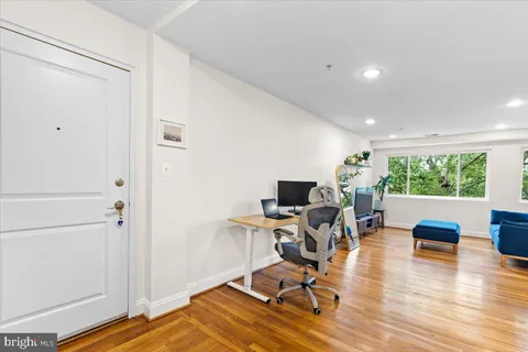 a kitchen with granite countertop a stove a sink and a refrigerator