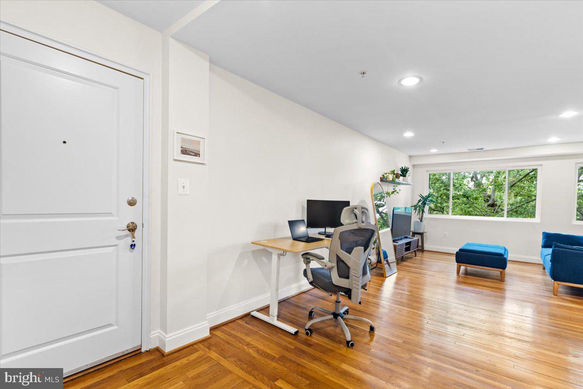 804 Taylor Street Northwest, Unit 403 Washington, DC 20011 - Photo 12 of 35 a view of a livingroom with workspace and a window