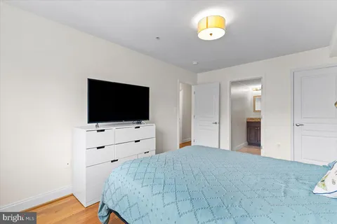 a bedroom with a bed and a flat screen tv