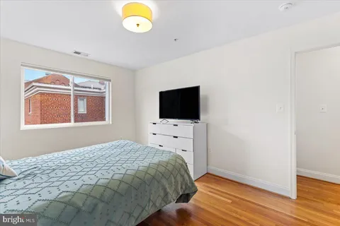 a bathroom with a granite countertop toilet sink and mirror