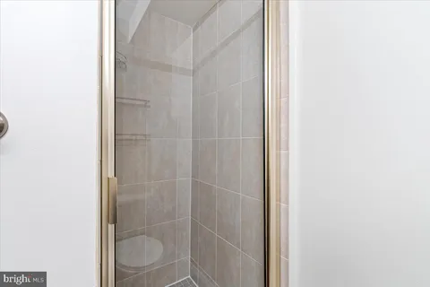 a bathroom with a granite countertop toilet sink and shower