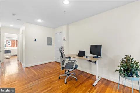 a view of workspace with wooden floor windows