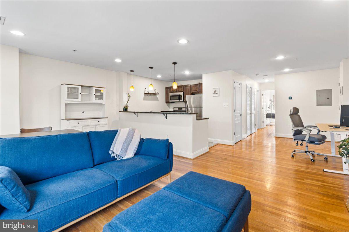 804 Taylor Street Northwest, Unit 403 Washington, DC 20011 - Photo 10 of 35 a living room with furniture and a wooden floor