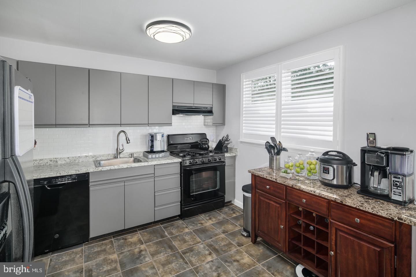 3230 Birch Road Philadelphia, PA 19154 - Photo 14 of 38 a kitchen with a sink stove and cabinets