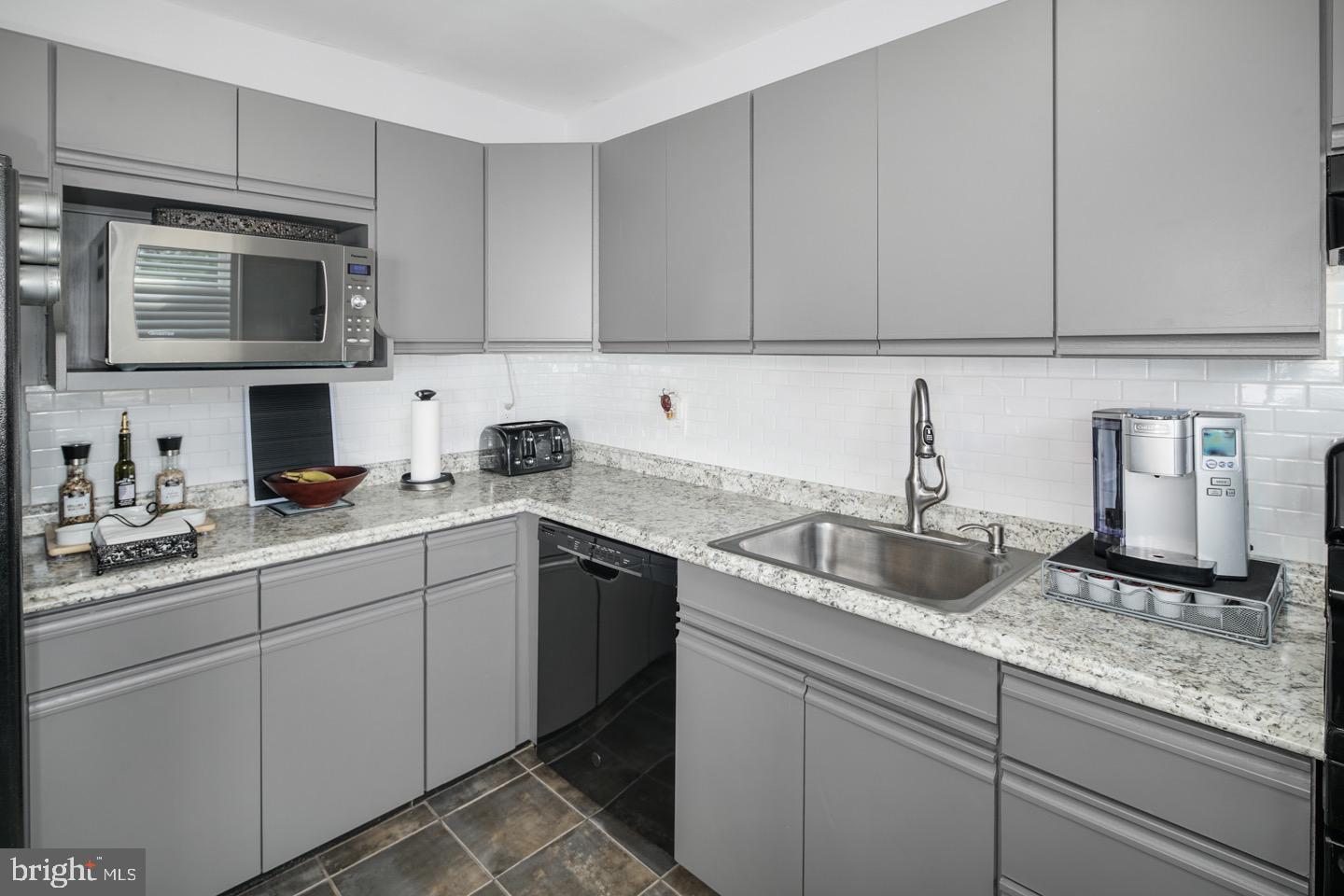 3230 Birch Road Philadelphia, PA 19154 - Photo 16 of 38 a kitchen with stainless steel appliances granite countertop a sink stove and microwave