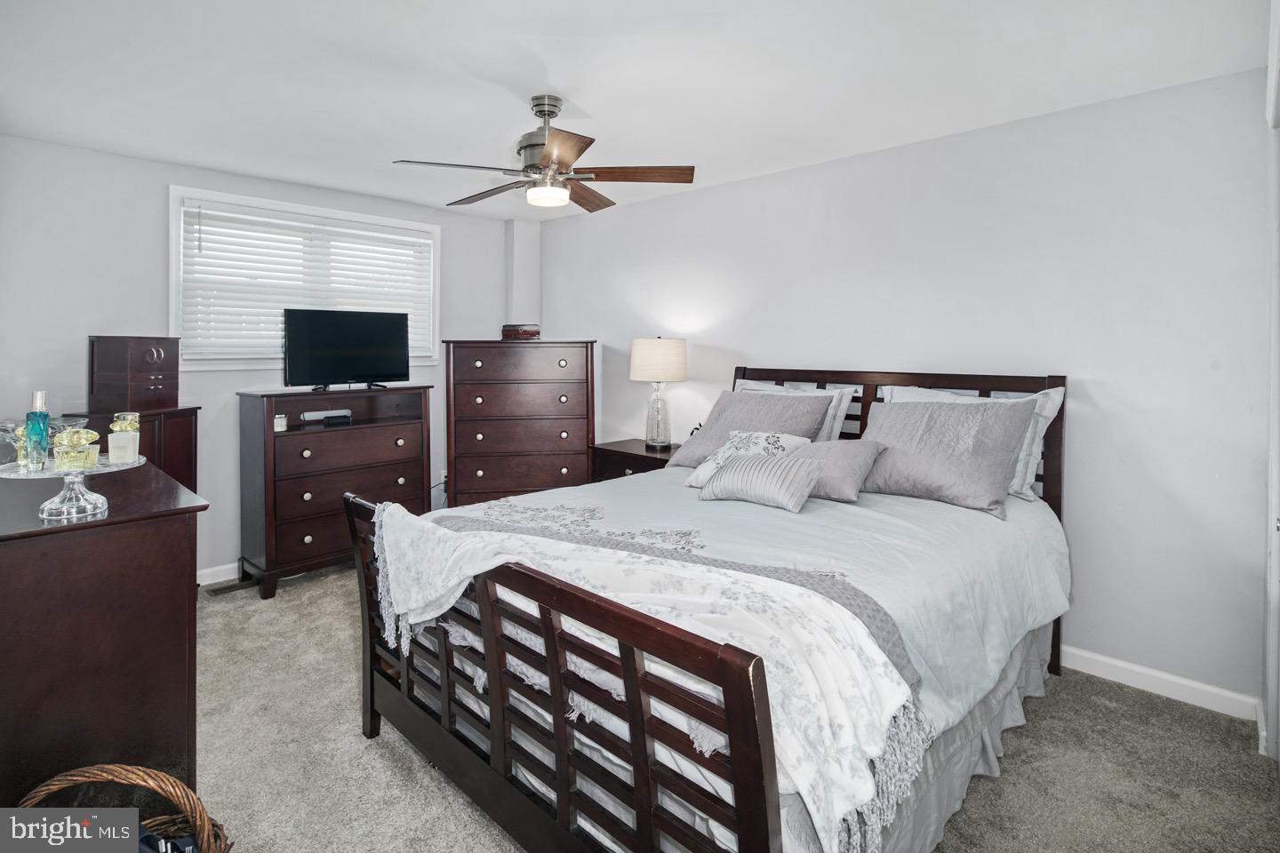 3230 Birch Road Philadelphia, PA 19154 - Photo 17 of 38 a bedroom with a bed and a flat tv screen on a dresser