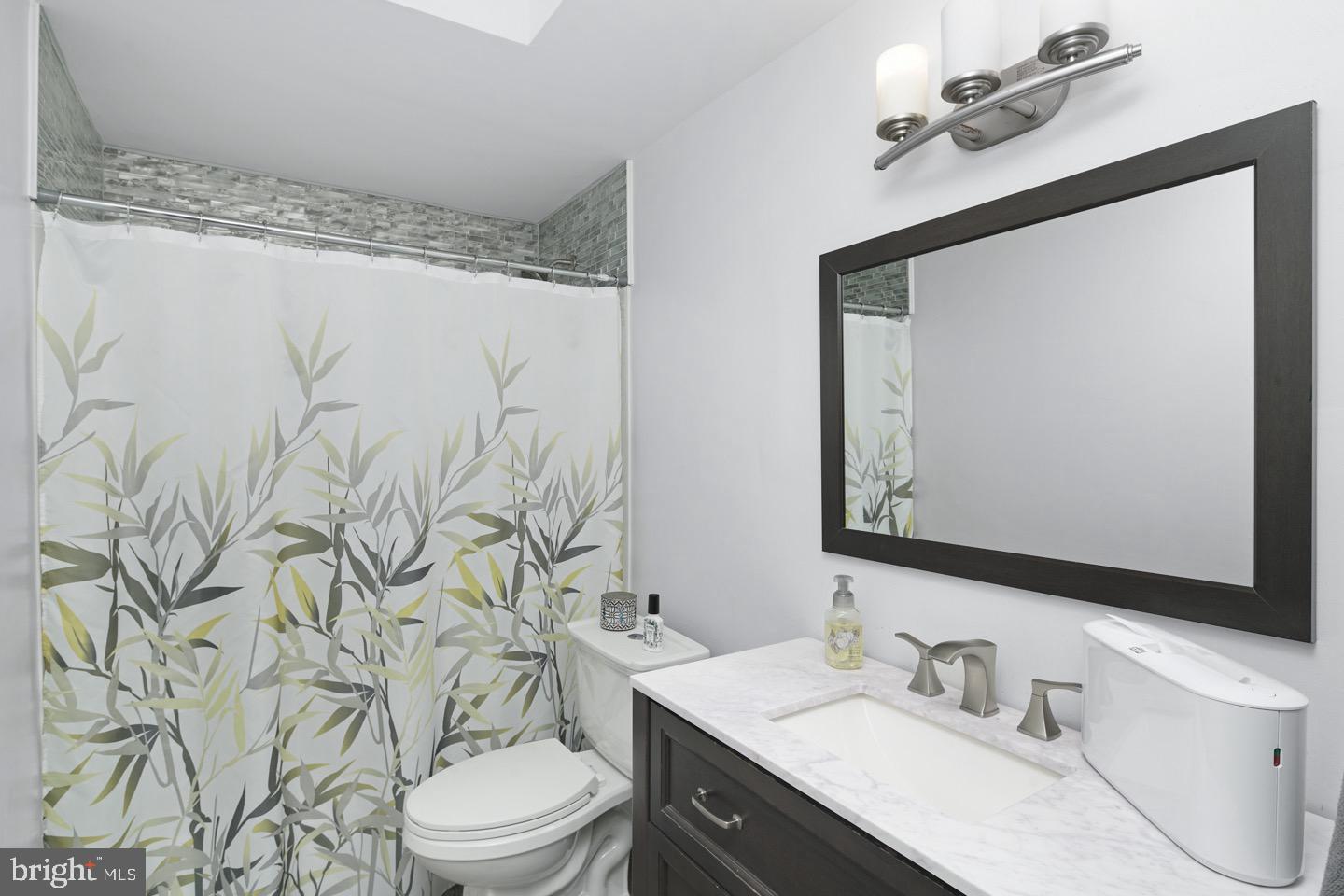 3230 Birch Road Philadelphia, PA 19154 - Photo 19 of 38 a bathroom with a toilet sink and mirror