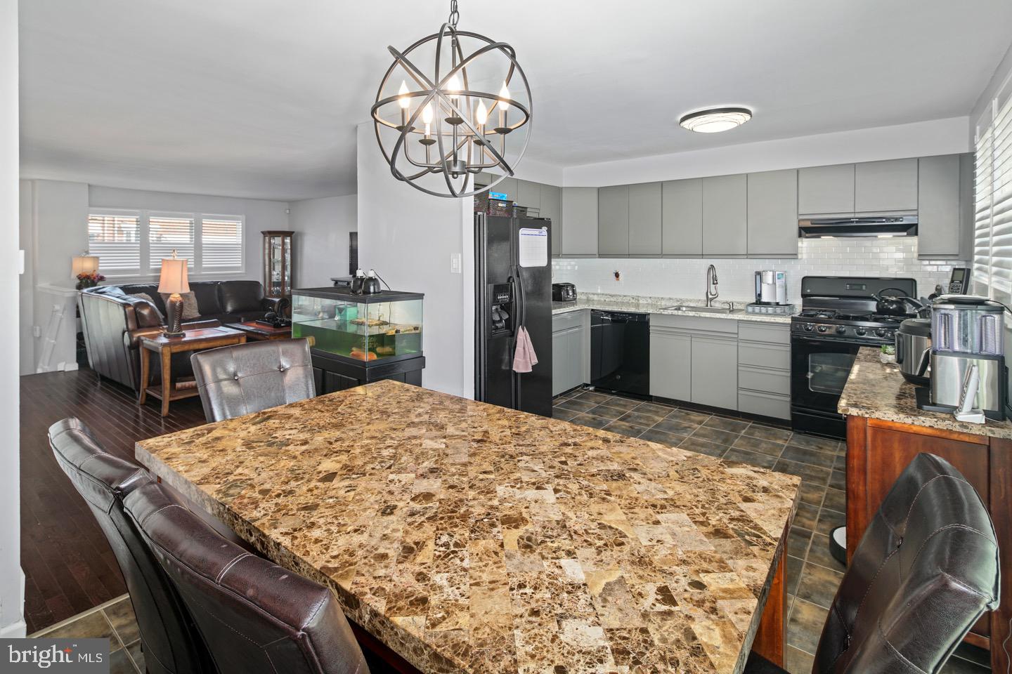 3230 Birch Road Philadelphia, PA 19154 - Photo 10 of 38 a kitchen with stainless steel appliances granite countertop a sink dishwasher stove refrigerator dining table and chairs