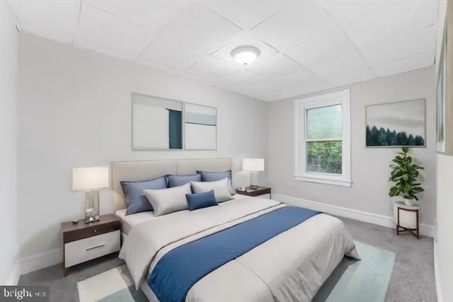 a bedroom with a bed lamp and window