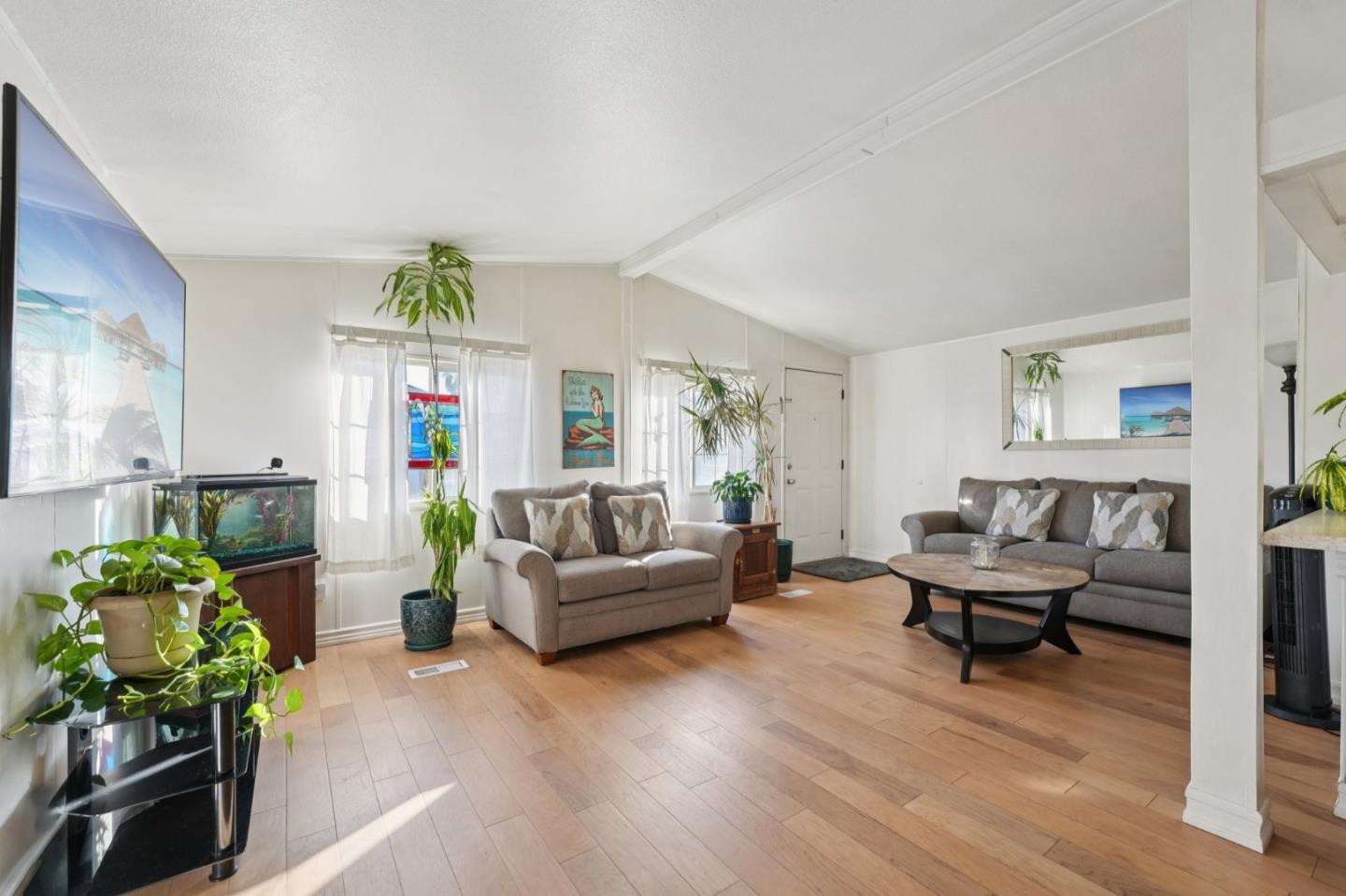 a living room with furniture and a wooden floor