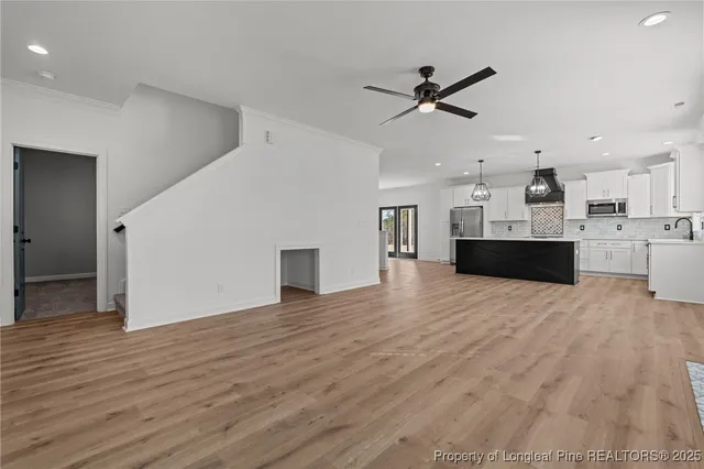 a living room with a fireplace and a wooden floor