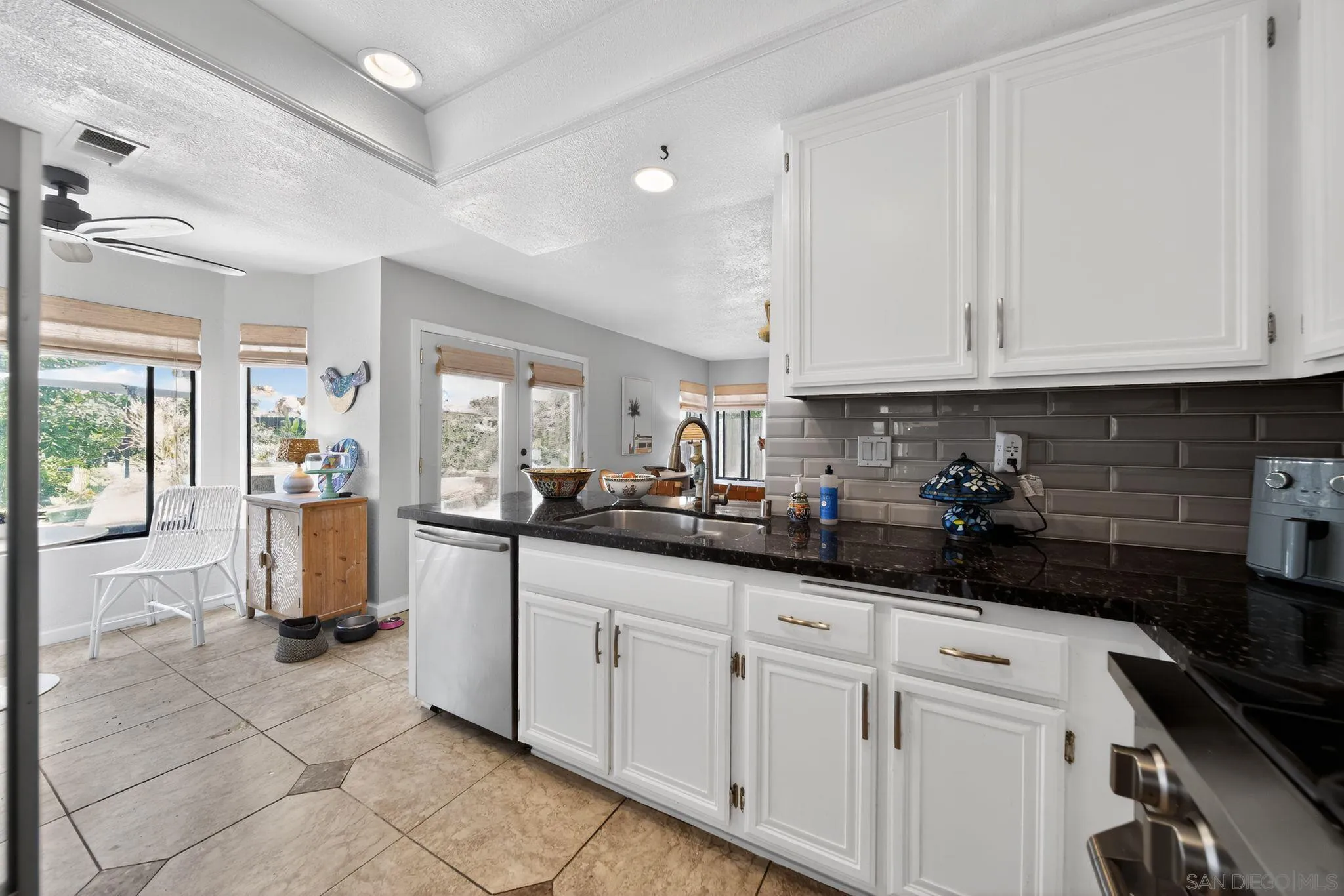 5287 Rio Plata Drive Oceanside, CA 92057 - Photo 18 of 38 a kitchen with a sink and refrigerator