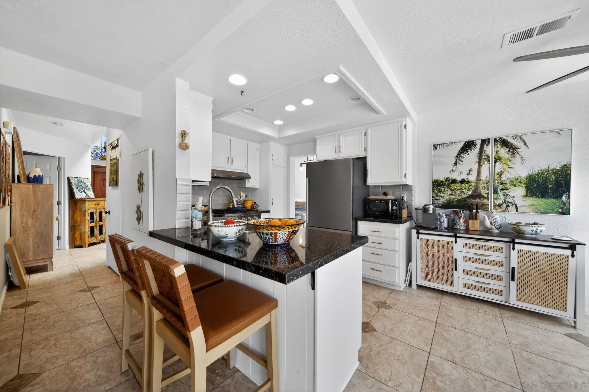5287 Rio Plata Drive Oceanside, CA 92057 - Photo 19 of 38 a kitchen with stainless steel appliances kitchen island granite countertop a refrigerator and a stove top oven