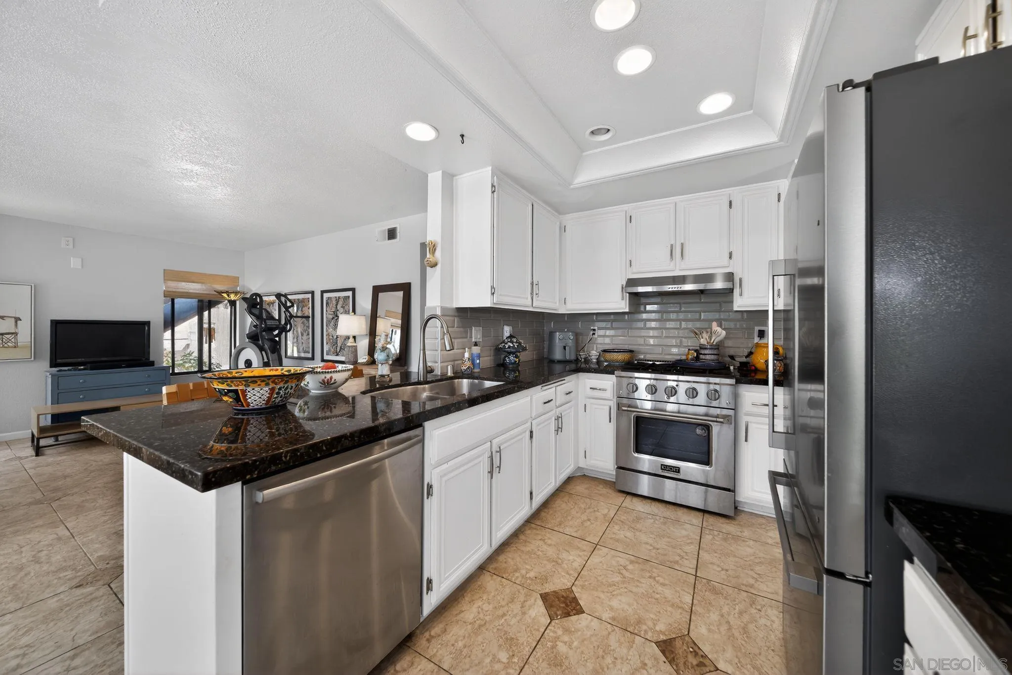 5287 Rio Plata Drive Oceanside, CA 92057 - Photo 20 of 38 a kitchen with stainless steel appliances granite countertop a sink and cabinets
