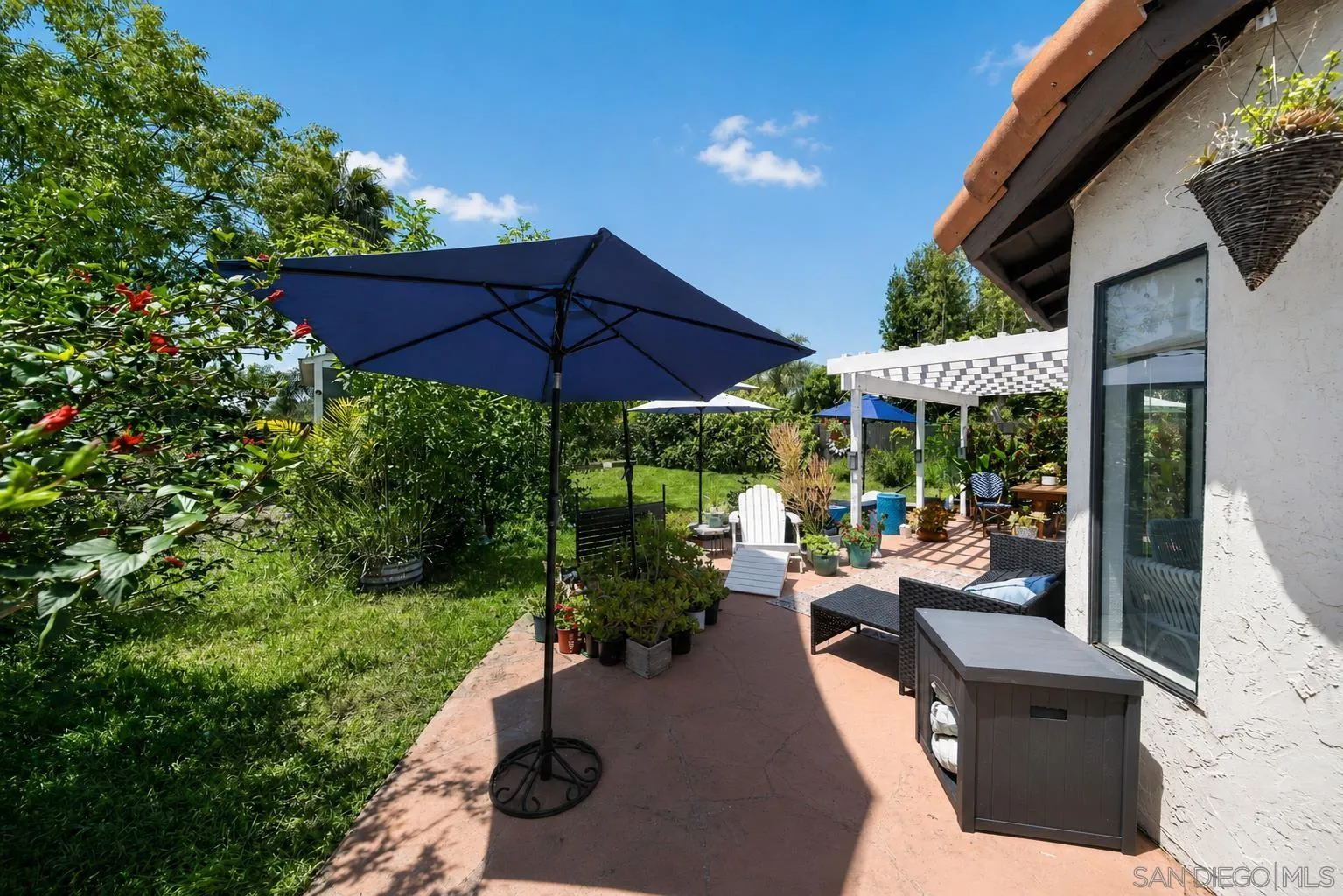 5287 Rio Plata Drive Oceanside, CA 92057 - Photo 22 of 38 a view of a patio with chairs and a table and chairs under an umbrella