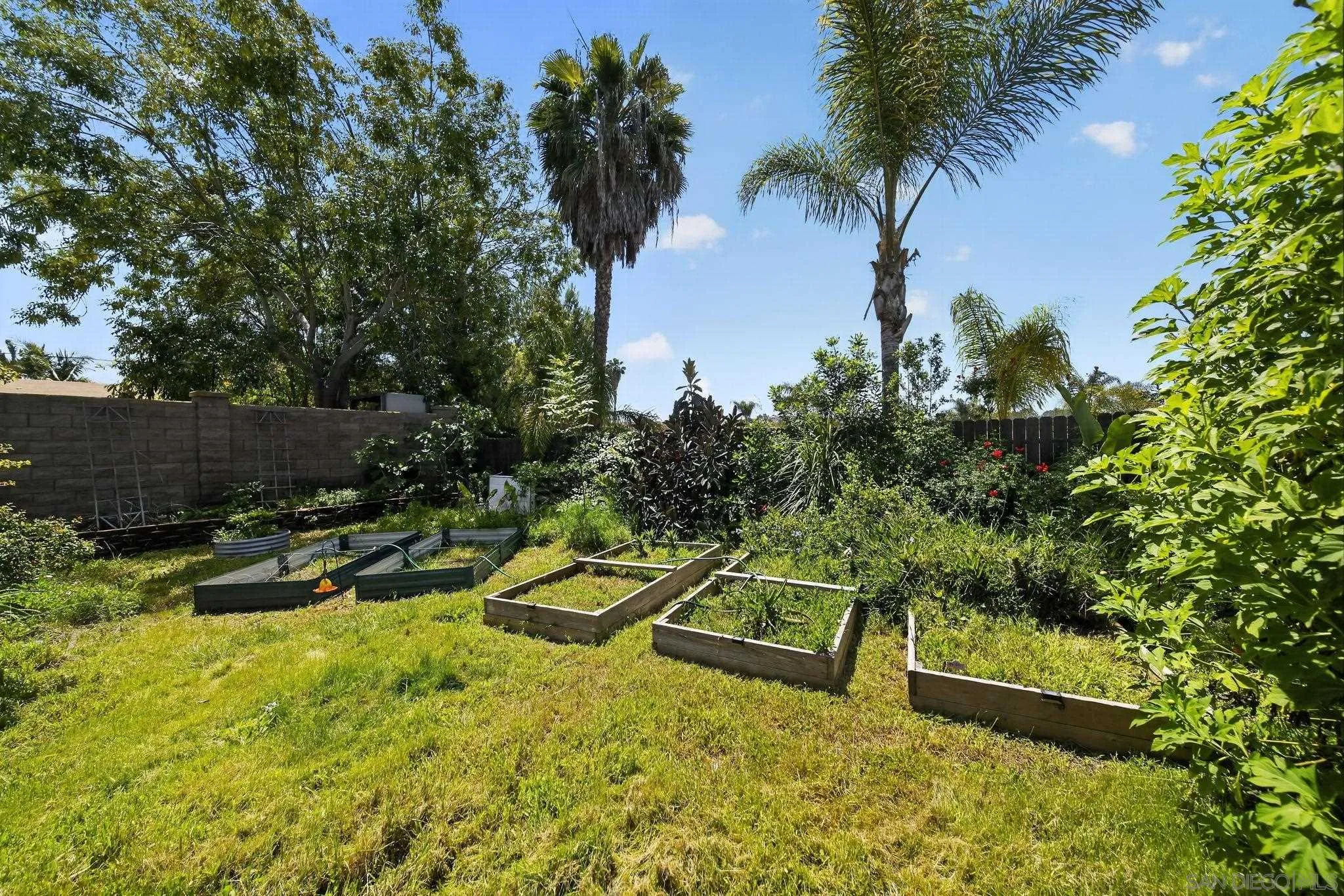 5287 Rio Plata Drive Oceanside, CA 92057 - Photo 27 of 38 a view of a swimming pool with a bench and trees