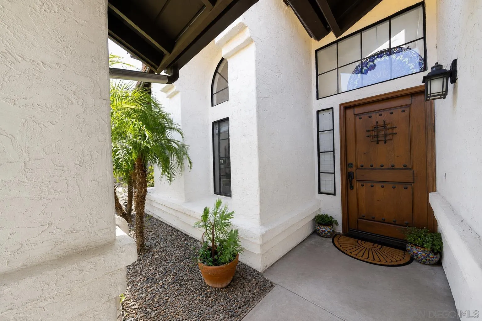 5287 Rio Plata Drive Oceanside, CA 92057 - Photo 3 of 38 a potted plant in front of a door