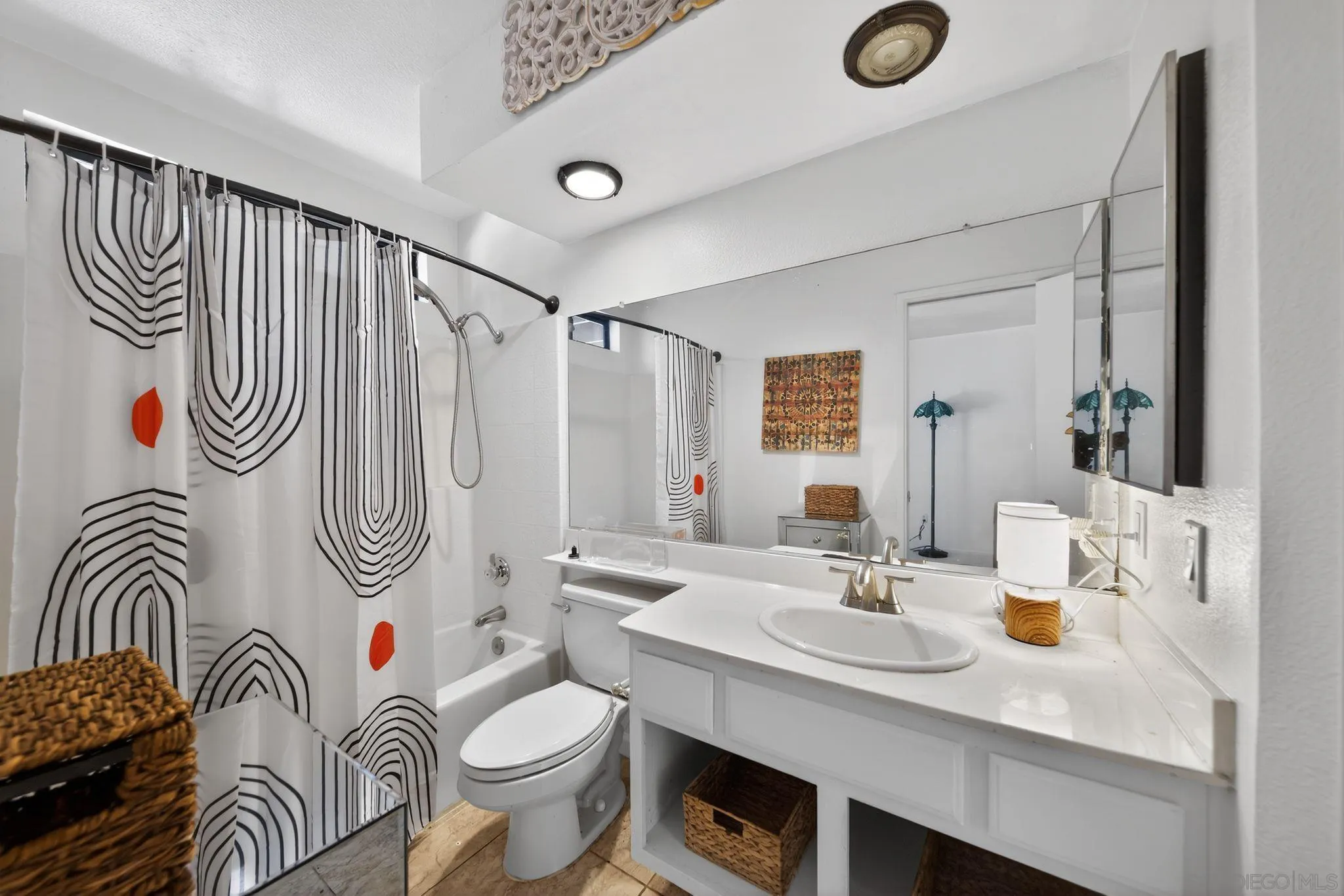 5287 Rio Plata Drive Oceanside, CA 92057 - Photo 9 of 38 a bathroom with a sink a toilet and shower curtain