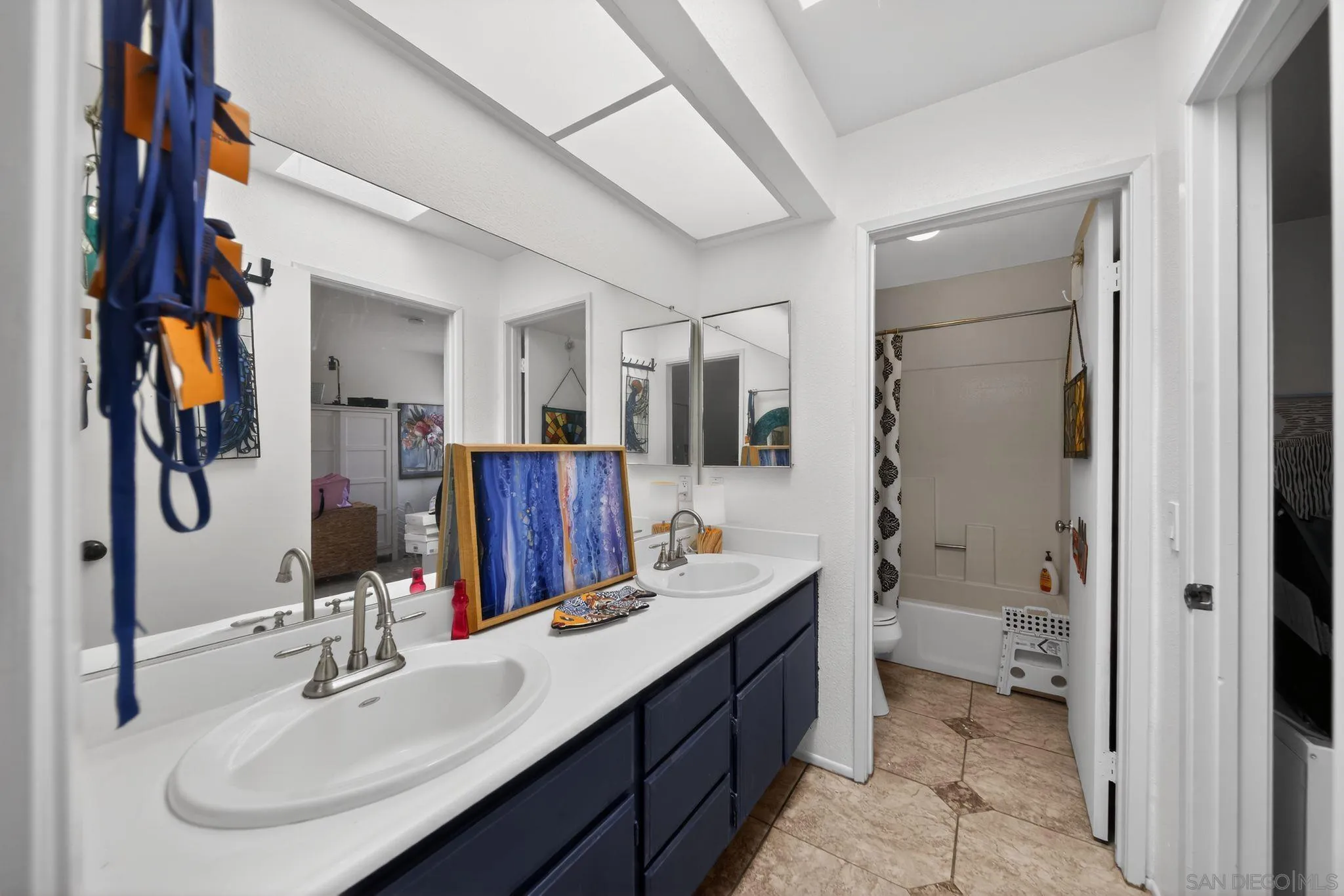 5287 Rio Plata Drive Oceanside, CA 92057 - Photo 10 of 38 a bathroom with a double vanity sink toilet and shower