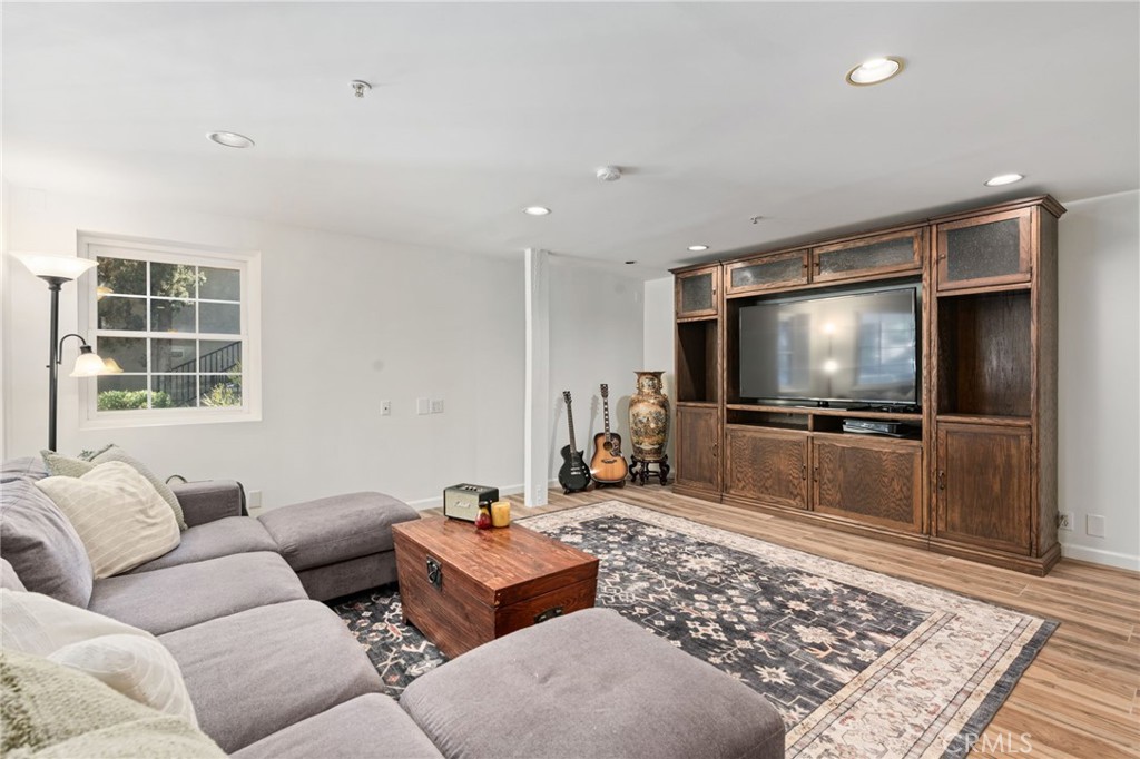 9729 Marcus Lane Tujunga, CA 91042 - Photo 27 of 55 a living room with furniture and a flat screen tv