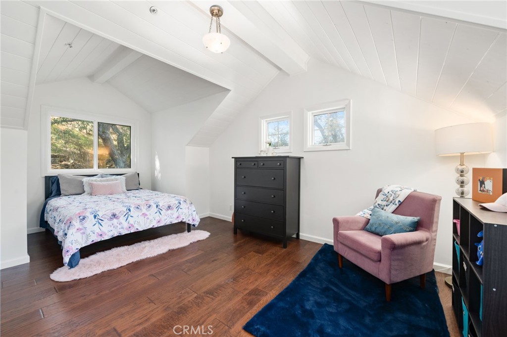 9729 Marcus Lane Tujunga, CA 91042 - Photo 39 of 55 a bedroom with a bed and wooden floor