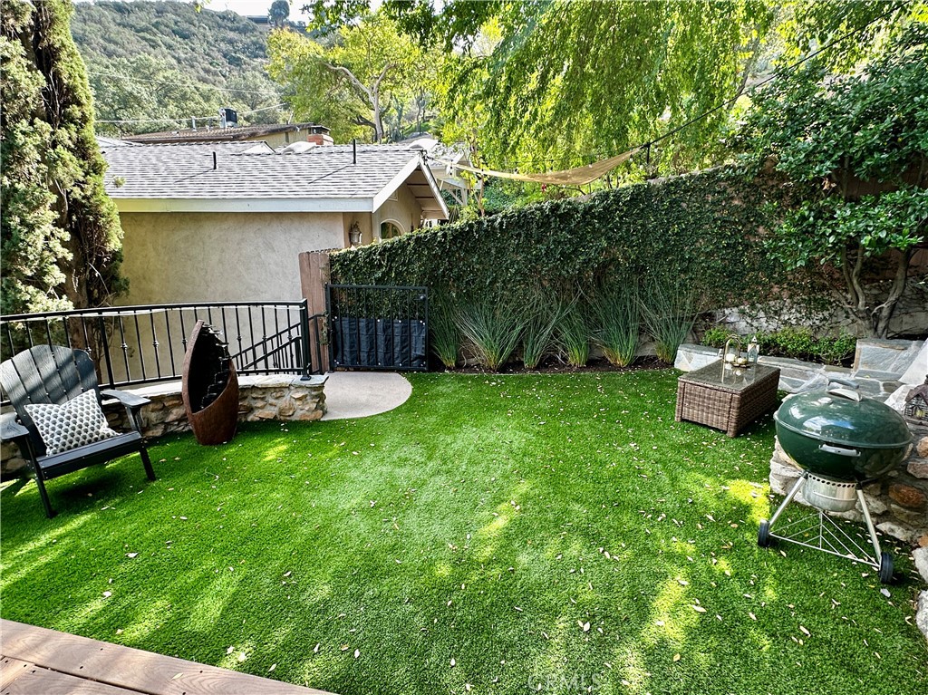 9729 Marcus Lane Tujunga, CA 91042 - Photo 49 of 55 a view of a chair and table in backyard of the house