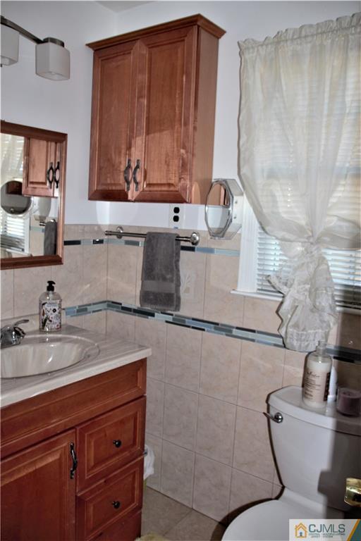 75 Rodak Circle Edison, NJ 08817 - Photo 20 of 32 a bathroom with a granite countertop sink a toilet and mirror