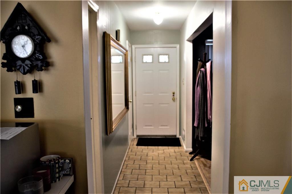 75 Rodak Circle Edison, NJ 08817 - Photo 4 of 32 a view of a hallway with wooden floor and a bathroom with sink