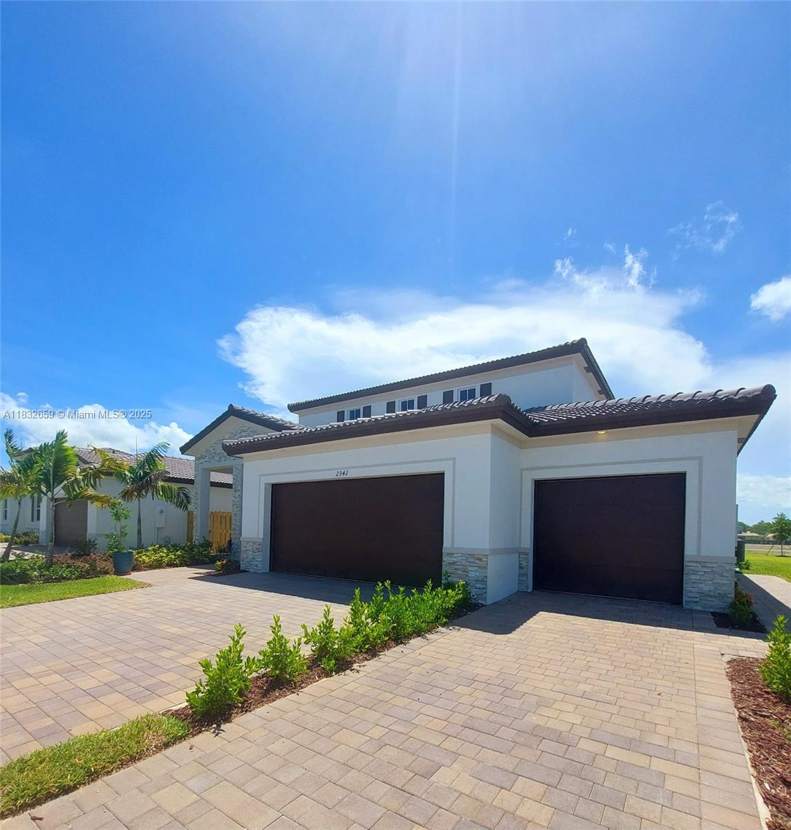 2942 Southeast 23rd Avenue Homestead, FL 33035 - Photo 1 of 20 a front view of a house with a yard and garage