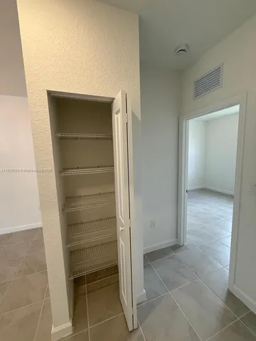 an empty room with a empty space and windows