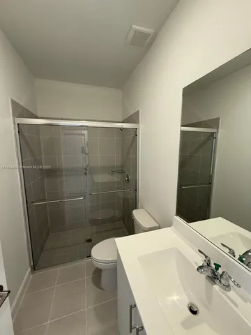 a view of an empty room and closet area