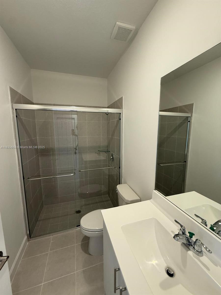 2942 Southeast 23rd Avenue Homestead, FL 33035 - Photo 13 of 20 a bathroom with a sink a toilet and shower