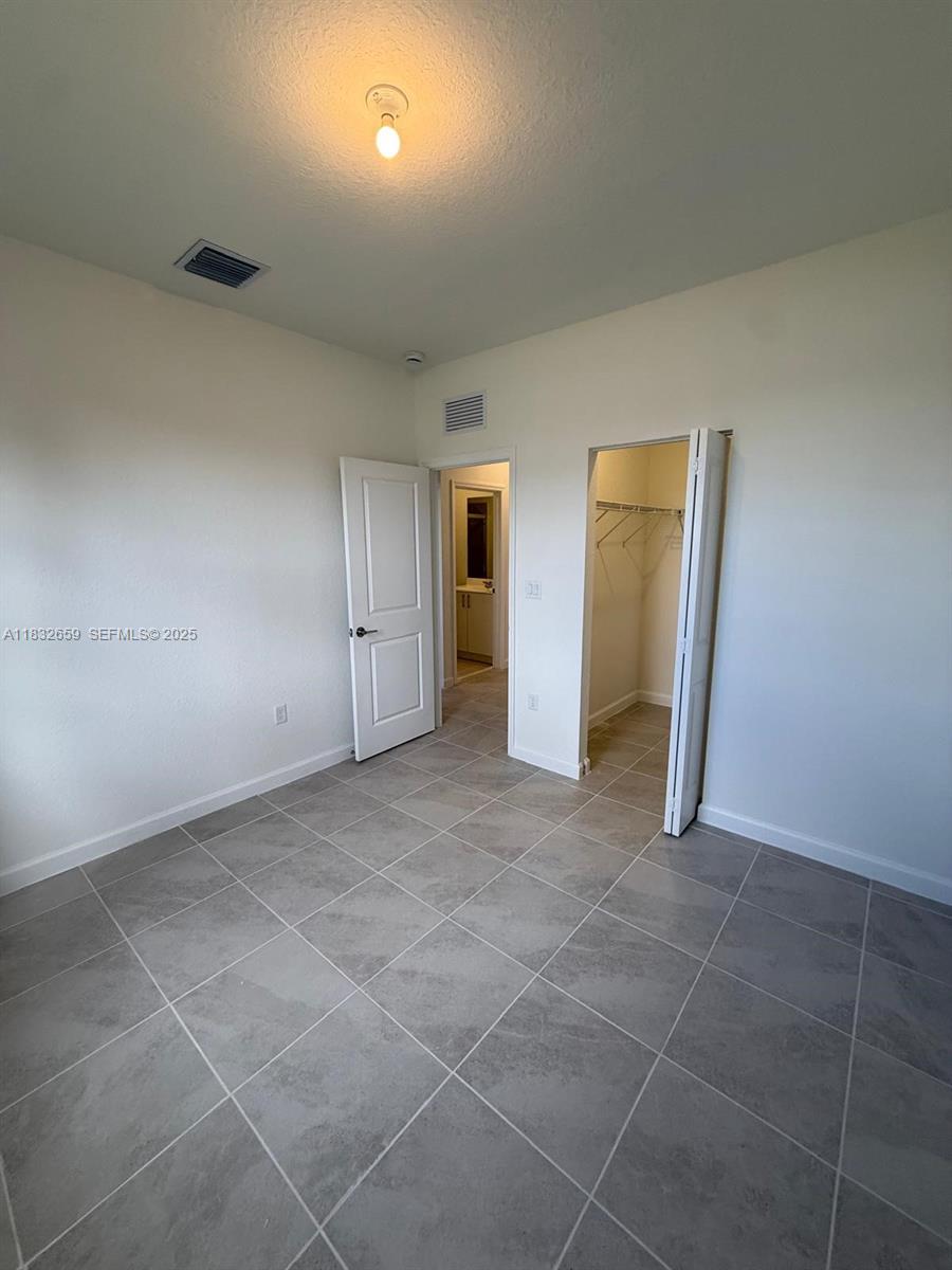 2942 Southeast 23rd Avenue Homestead, FL 33035 - Photo 15 of 20 a view of an empty room and closet area
