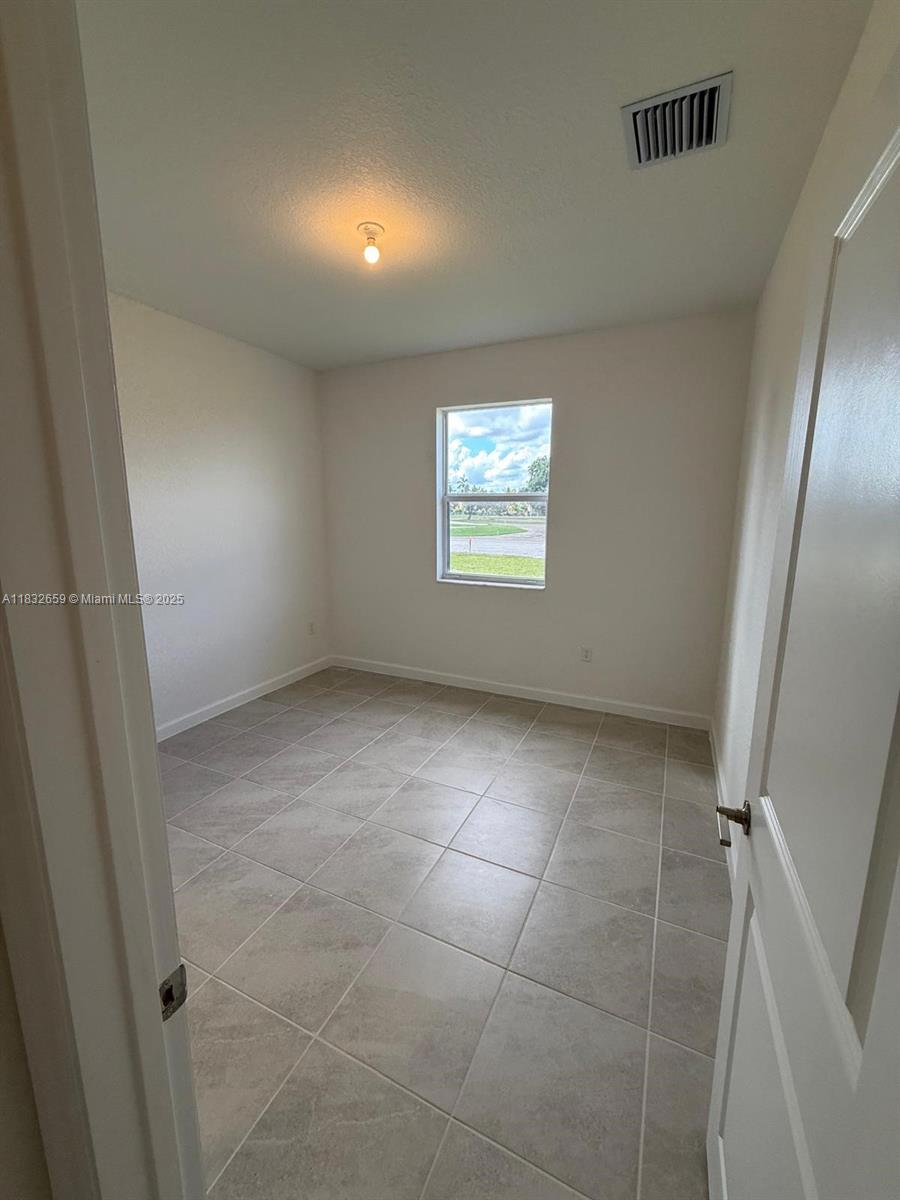 2942 Southeast 23rd Avenue Homestead, FL 33035 - Photo 18 of 20 a view of an empty room with a window