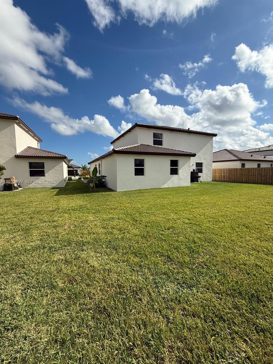 2942 Southeast 23rd Avenue Homestead, FL 33035 - Photo 20 of 20 a large white house with a big yard and large trees