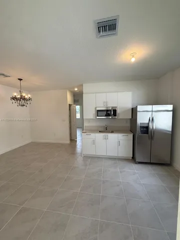 a large kitchen with cabinets and stainless steel appliances