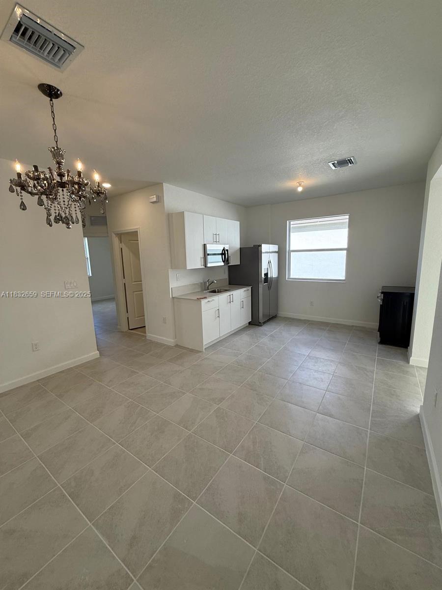 2942 Southeast 23rd Avenue Homestead, FL 33035 - Photo 8 of 20 a view of a livingroom with furniture and chandelier